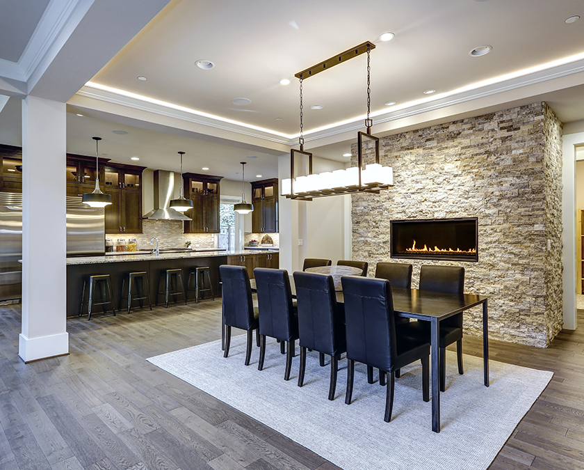 Open concept kitchen with stone wall fireplace