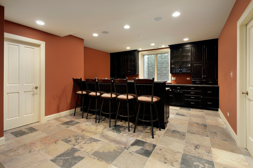 Bar in basement with dark wood cabinetry