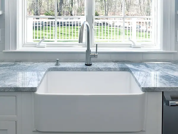 Undermount sink in a kitchen with dark blue counters
