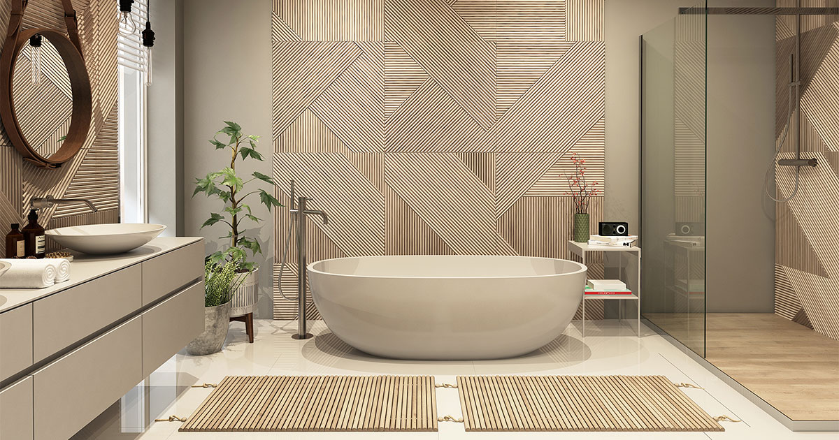 A beige bathroom with a glass walk-in shower, a free standing tub, and decorative walls