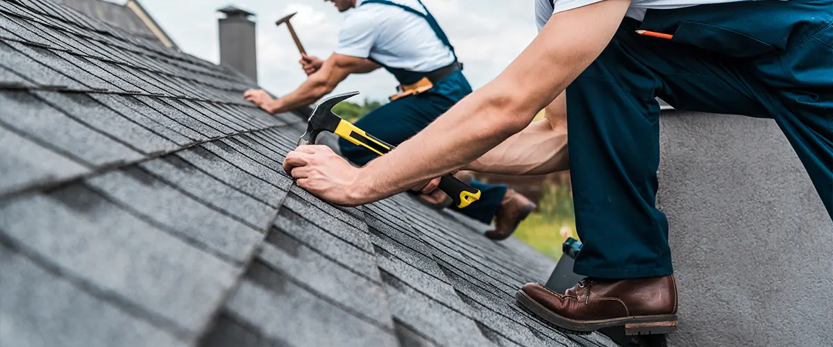 Roofing contractors repairing a home