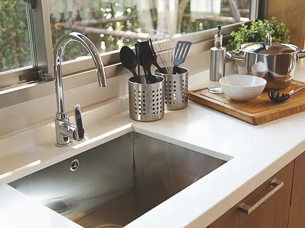 An undermount sink with silver hardware