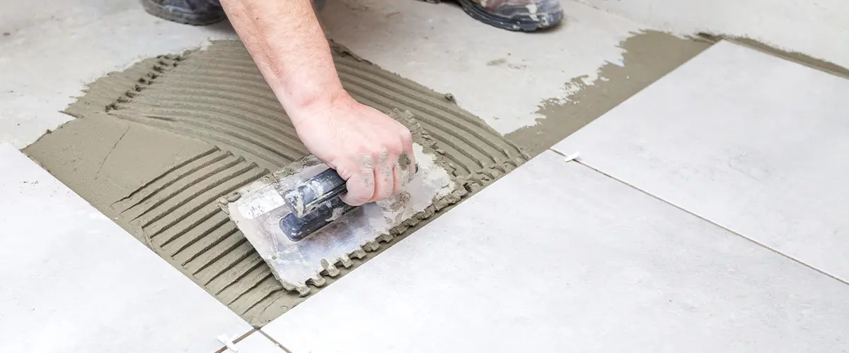 A bathroom remodeler in northern Virginia working on tile flooring