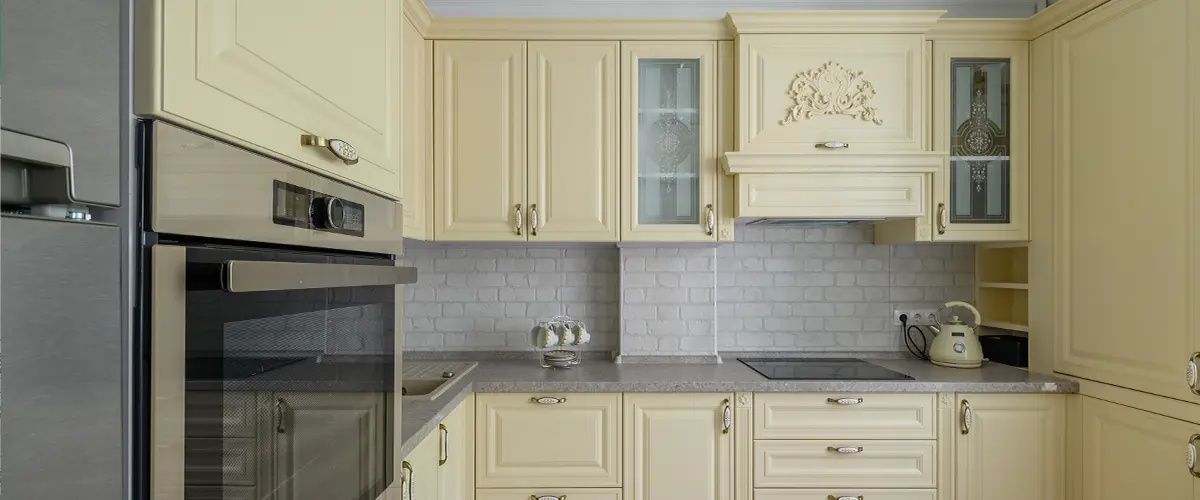 Beige cabinets with silver appliances