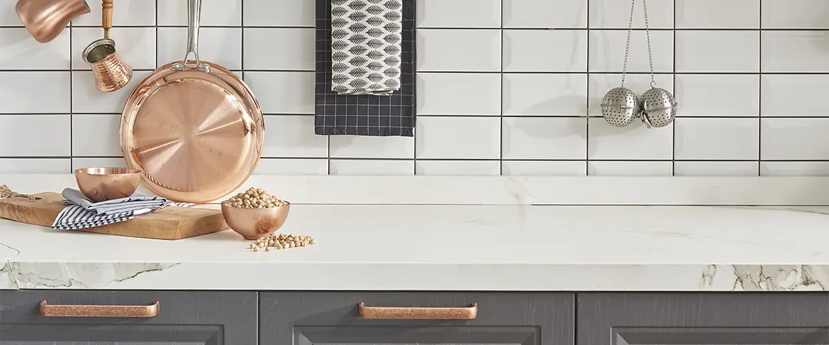 A kitchen countertop with golden kitchen hardware