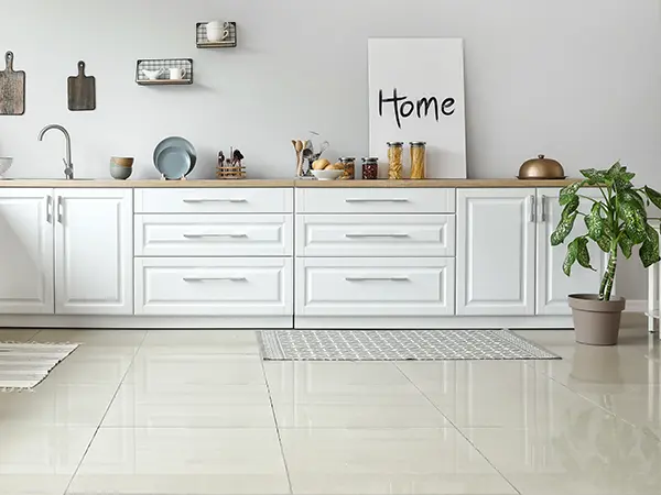 Tile flooring in a kitchen with white cabinets
