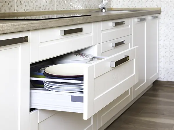 A cabinet shelf with silver pulls