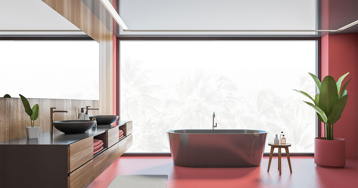 Red bathroom lighting with freestanding tub and plant