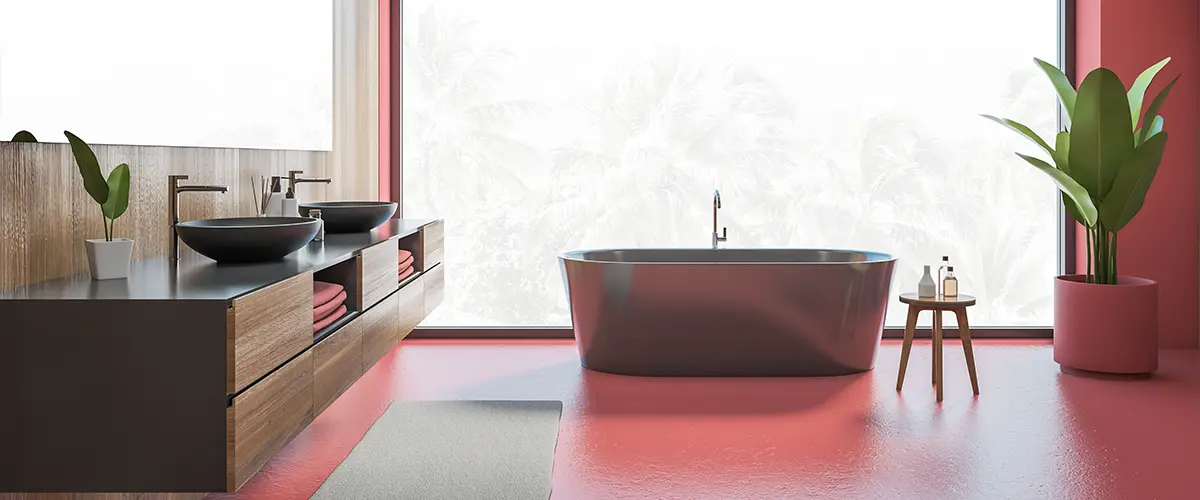 Red bathroom lighting with freestanding tub and plant