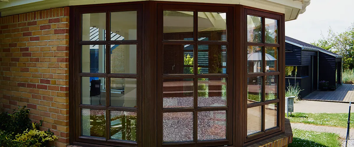 Sunroom addition with brown window frames