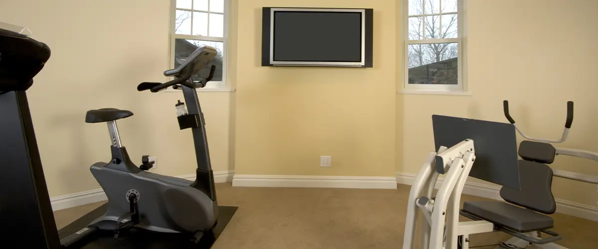A gym in a basement painted beige