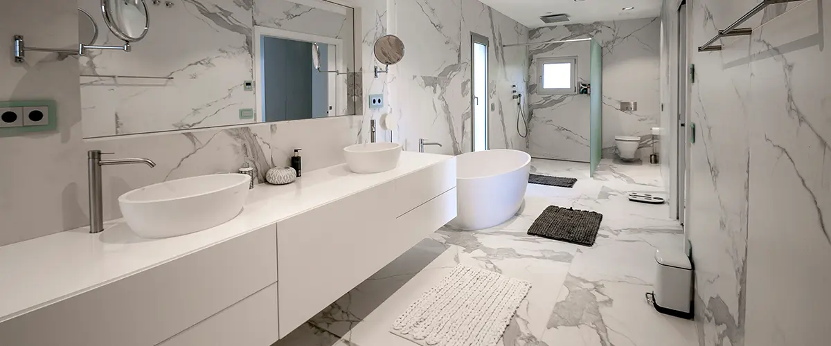 A large bathroom with modern vanities and tile flooring
