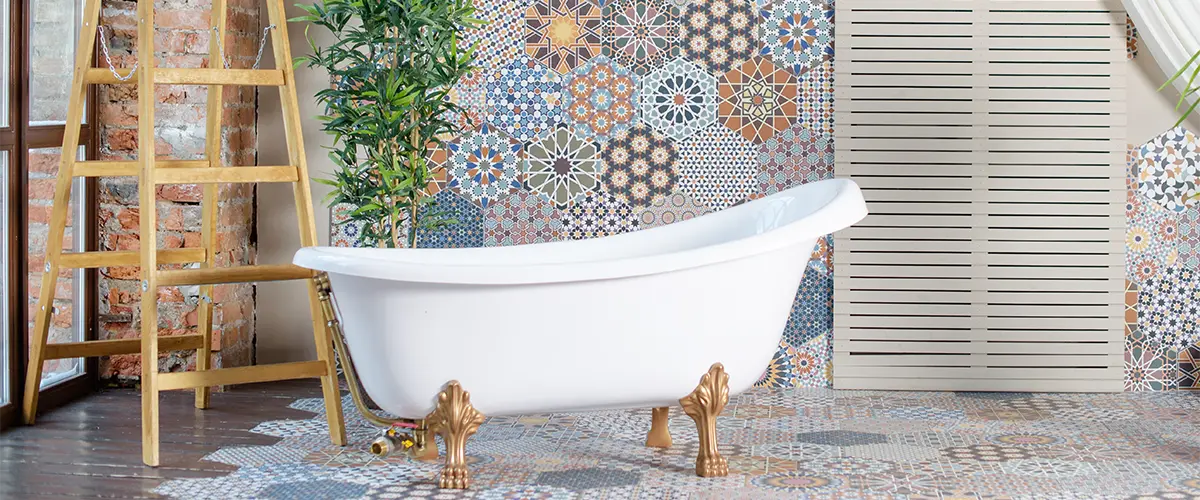 A beautiful bathroom with a tile design and a freestanding tub