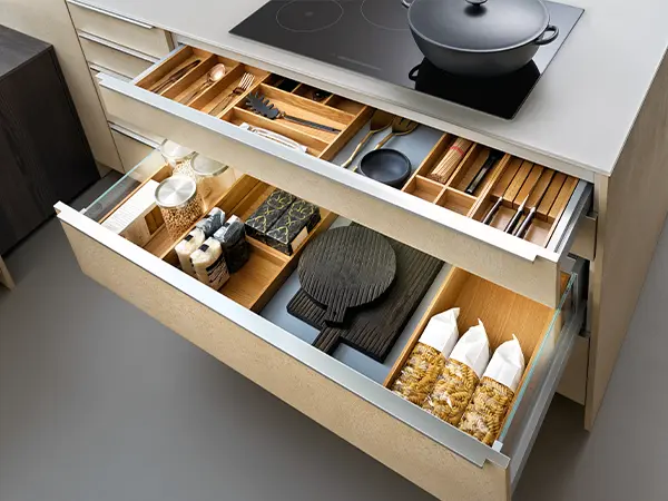 Kitchen cabinets with open drawers and kitchen utensils