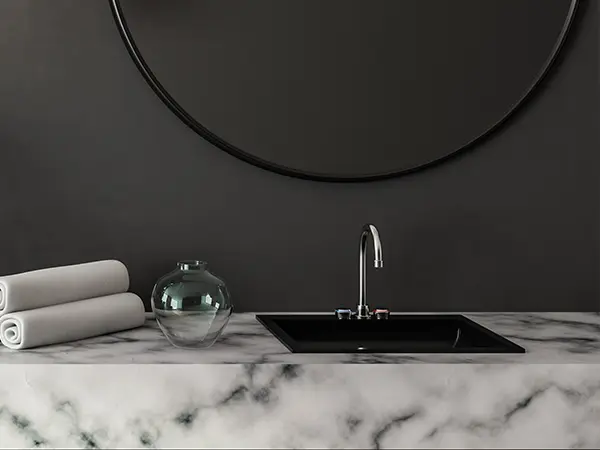 A marble countertop in a fancy, black bathroom