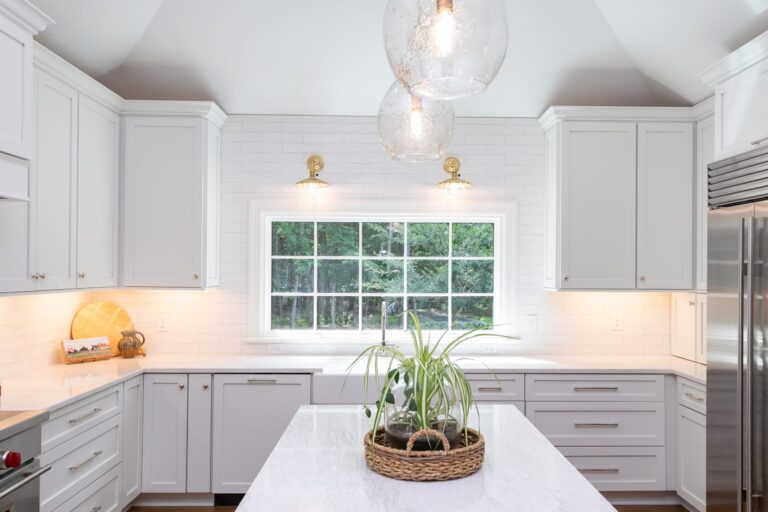 white marble kitchen with lights on