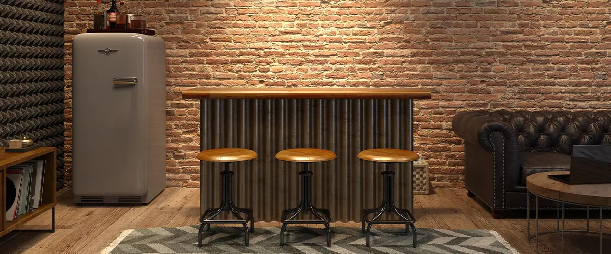 A bar in a basement with brick walls and a fridge