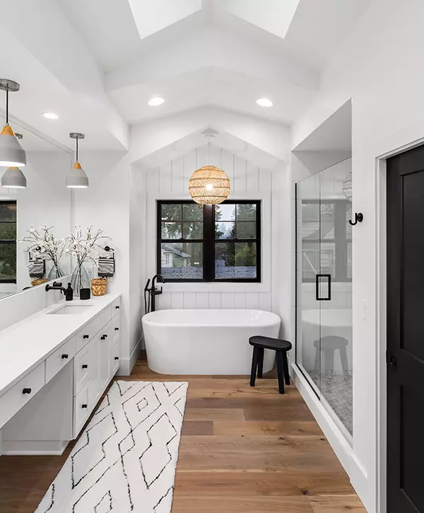 Beautiful bathroom remodeling in luxury stone ridge home with double vanity, bathtub, mirror, sinks, shower, and hardwood floor